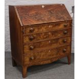 A Georgian flame mahogany bureau with fitted interior over four graduated drawers on bracket feet.