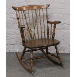 A wooden spindle back rocking chair.