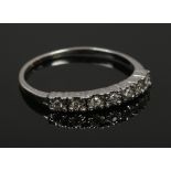 A white gold and diamond half eternity ring, not marked size L, 13.9 grams.