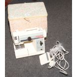 A cased electric Singer sewing machine.