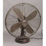 A large vintage painted metal electric fan.