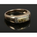 A 9ct gold and diamond ring with quartz tablet having gold inclusions, size V.