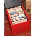 A storage case of 45rpm singles with sleeves, tribute to Buddy Holly, Elvis Presley, The Beatles