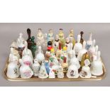 A tray of ceramic bells to include Madame Tussauds, Petticoats and Pantaloons examples.