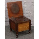 A Victorian mahogany commode raised on turned feet.