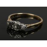 A ladies 18ct and platinum three stone diamond ring, size P, 2.44 grams.