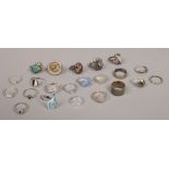 Twenty two silver dress rings including white and coloured paste examples.