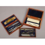 Two wooden cased drawing instrument sets.