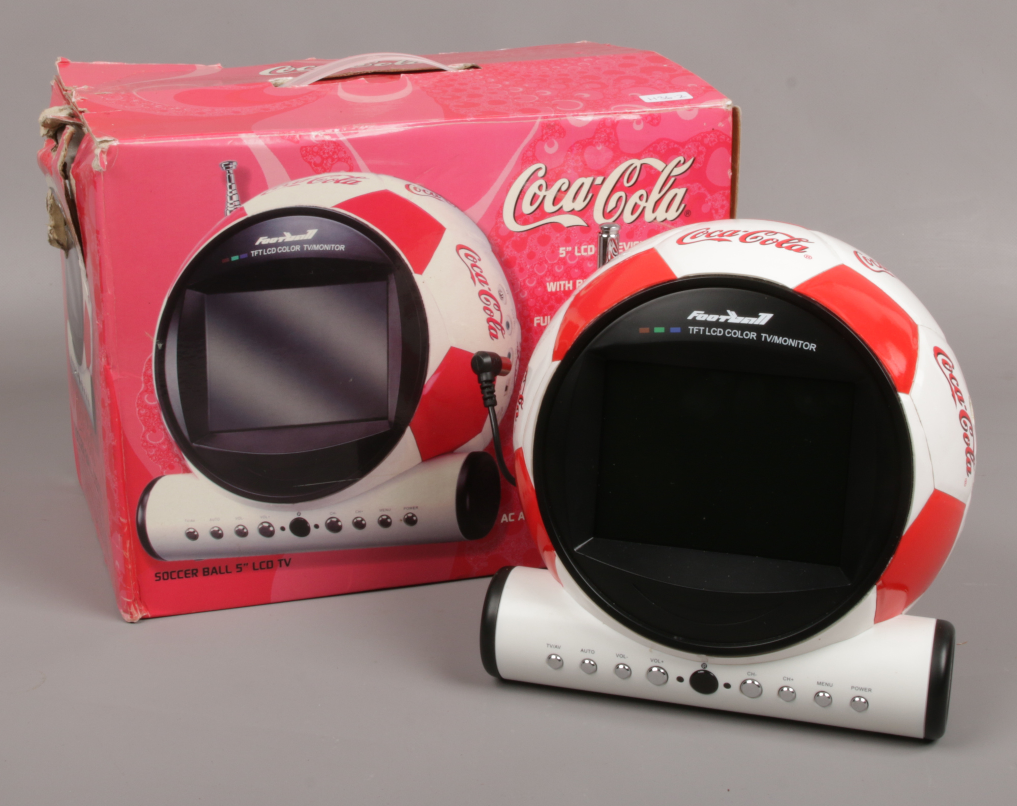 A Coca Cola 5 inch soccer ball LCD television in box.