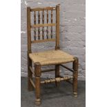 An ash and elm rush seat chair with turned supports.