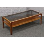 A teak mid century glass top coffee table with under storage shelf, 104cm x 46cm x 36cm