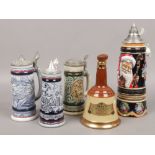 Four steins to include musical example, along with a Bells Whisky decanter