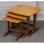 A nest of three teak tables.