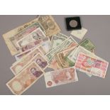 A collection of world bank notes including British pre decimal, Russian 1910 100 ruble and a boxed