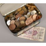 A tin of English and foreign coins.