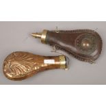 A 19th century pressed copper powder flask with shell motifs and brass mount along with a brass