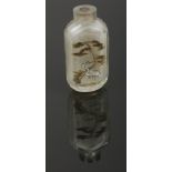 A Chinese glass scent bottle with cut mouldings. Painted inside out with a crane under a pine tree