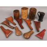 A collection of leather wares including a leather jack, flasks and three bottle holders.