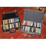 Two carry cases of pre recorded cassettes Johnny Cash, Willie Nelson, James Taylor, Chris Rea etc.