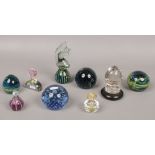 A collection of glass paperweights and scent bottles.