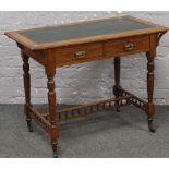 An oak two drawer writing desk.