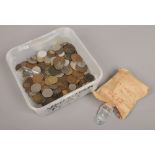 A collection of mainly foreign copper and silver coins and national transport tokens.