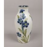 A James Macintyre & Co. miniature Florian ware vase design by William Moorcroft. Decorated over a