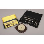 A Fowler's Universal calculator in leather case, along with two cased sets of drawing instruments.