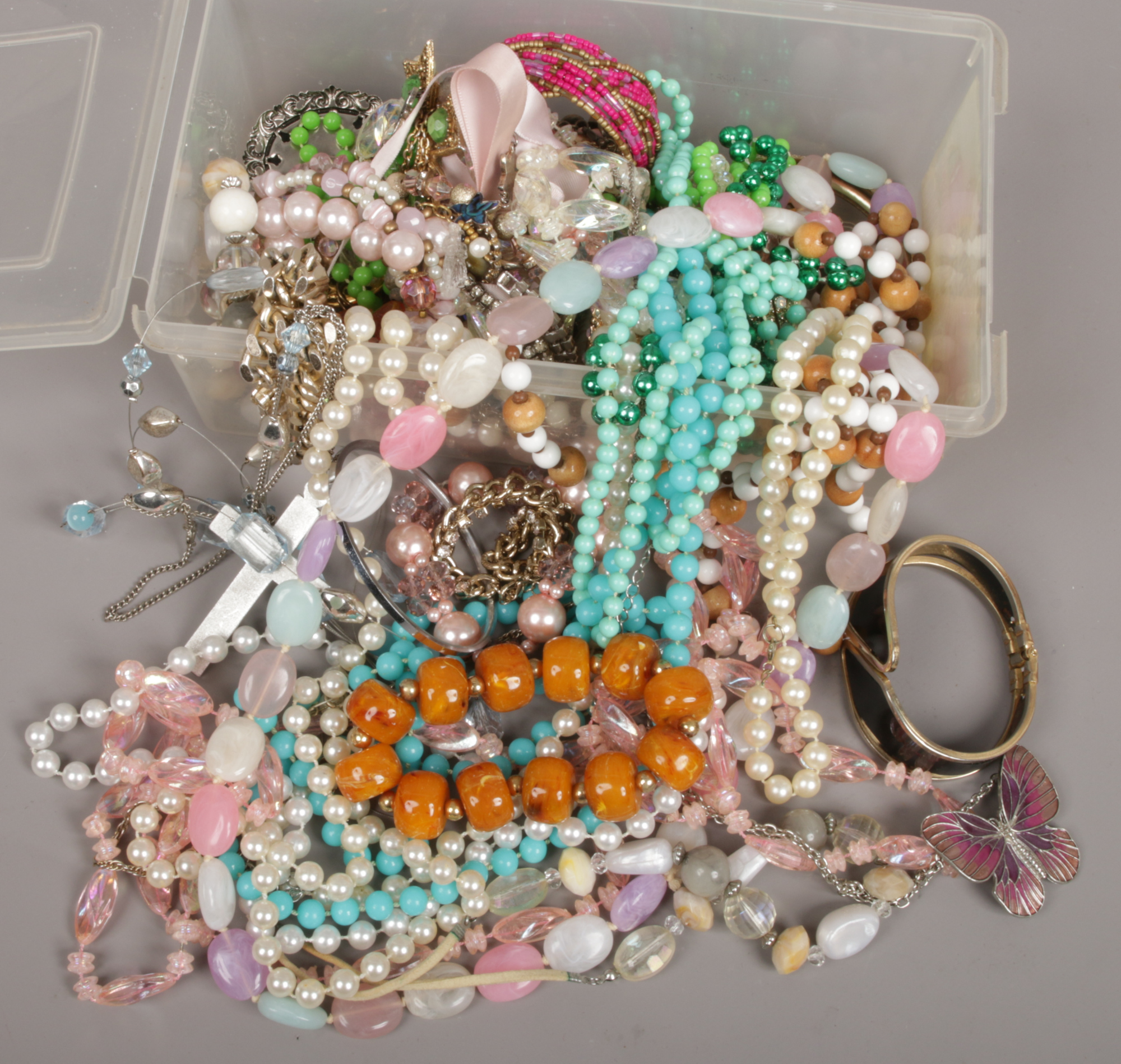 A box of costume jewellery beads, brooches, bangles etc.