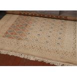 A Persian cream ground wool carpet with central diamond panel decoration, approximately 380cm x