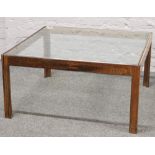 A large rosewood glass top coffee table, 93cm x 93cm.