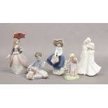 A collection of ceramic figures to include three Lladro examples etc.