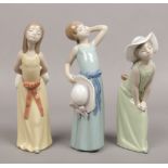 Three Lladro figures of young girls.