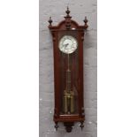 A mahogany 8 day wall clock.