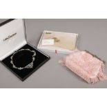 A cased ladies white metal necklace, along with two handbags, one Chinese silk the other with