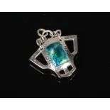 An Art Nouveau planished silver pendant with Ruskin style turquoise enamel centre. Assayed