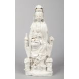 An 18th century Chinese blanc de chine statue of Guanyin and acolytes. Surrounded by precious