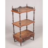 A Victorian figured walnut serpentine three tier whatnot stand with single drawer, 115cm high.