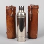 Two World War I Officers leather campaign flask cases. One containing a silver plated flask,