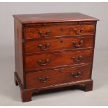 A George III mahogany bachelors chest of drawers. With crossbanded top, incorporating a brushing