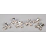 A set of six silver plated serviette rings. Each surmounted by a cast model of a recumbent setter