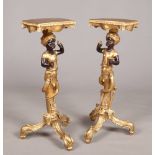 A pair of decorative Italian style gilt and ebonised figural Blackamoor torchere stands, 92cm high.