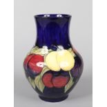 A large Moorcroft vase decorated in the Wisteria pattern over a cobalt blue ground. Impressed mark