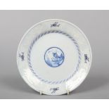 An 18th century English Delft dish. With bianco-soprao-bianco border and painted in blue and