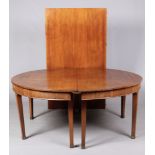 A large Regency mahogany D-end dining table with extra leaf and raised on square tapering