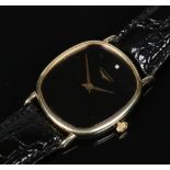 A gentleman's gold plated and stainless steel manual wristwatch. With black rounded rectangular dial