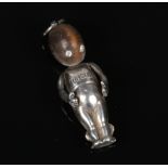 A World War I sweetheart Fumsup good luck charm. Hard wood and silver and with white paste eyes.