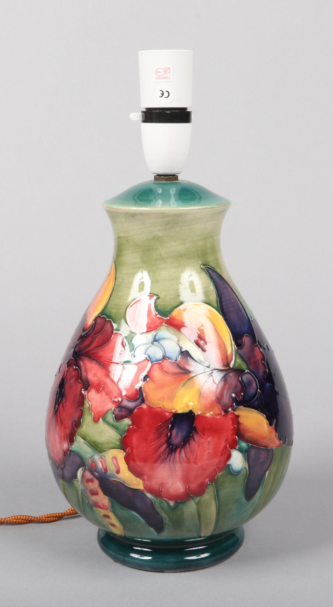 A large Moorcroft baluster shaped tablelamp. Green ground and decorated with the Spring Flowers