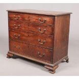 A George III mahogany chest of four graduated drawers. Oak lined, with bronze drop handles and