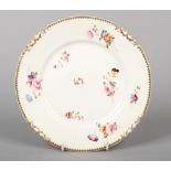 A Rockingham dessert plate with shark's tooth and S-scroll moulding. With serrated gilt rim and